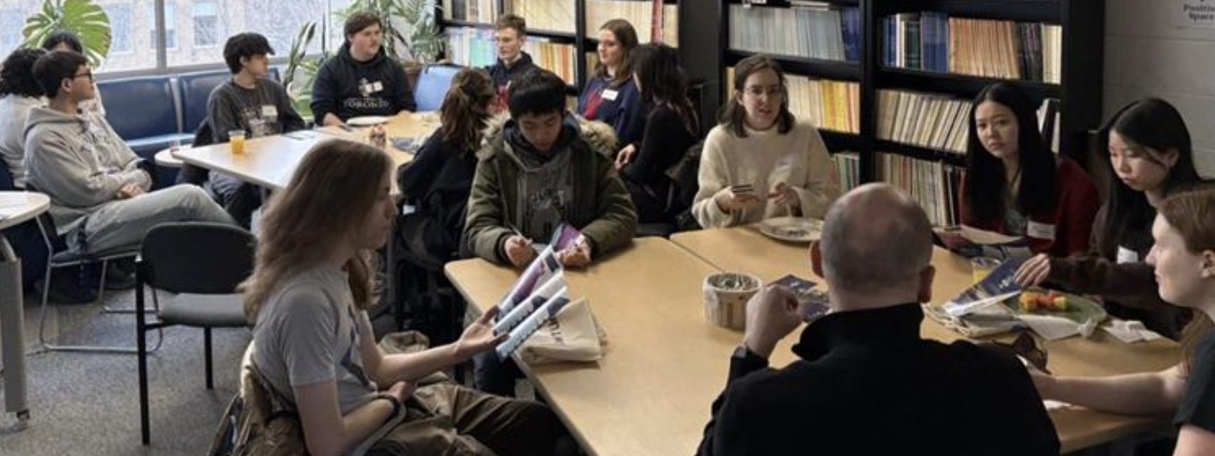 Profs nathan sanders, and pocholo umbal, and prospective linguistics students gathered at the tables in the linguistics lounge