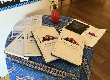 Copies of the new book laid out on a table with a small bouquet of flowers